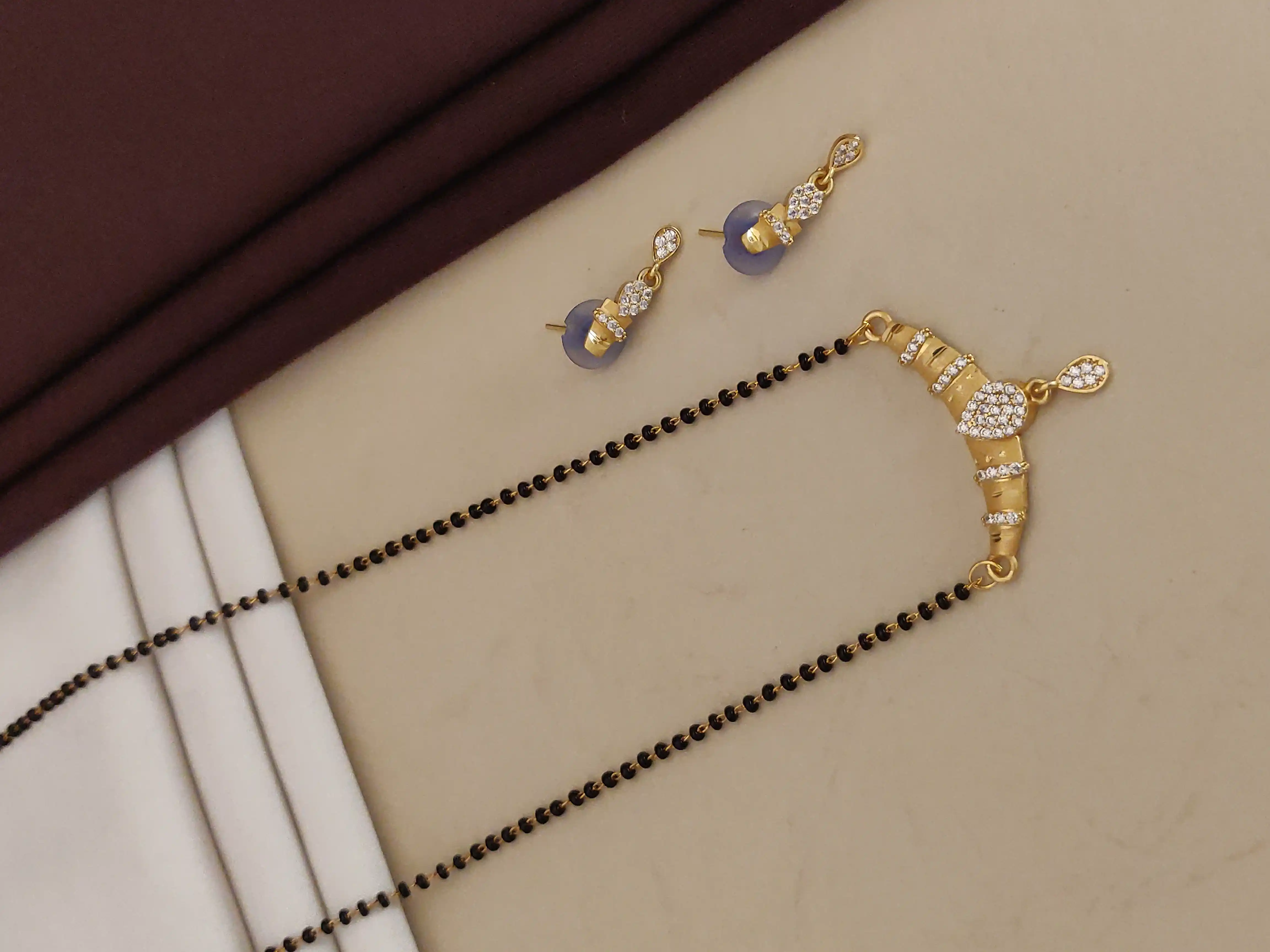 Forming ad diamond high gold plated oval mangalsutra   3 months guarantee.png